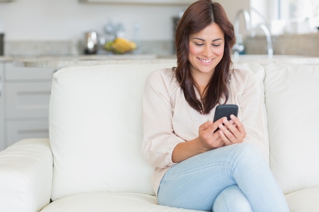 Brunette texting with mobile phone