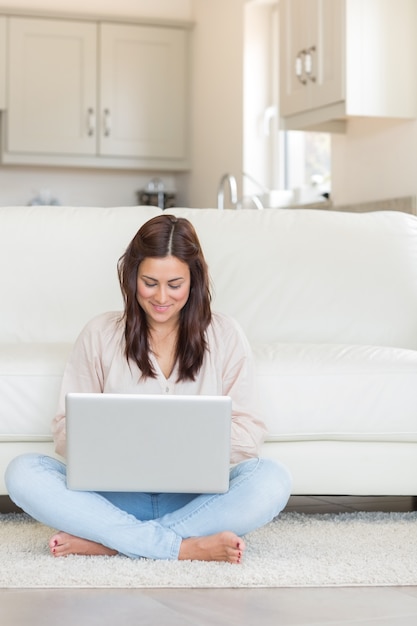 Brunette typing on laptop