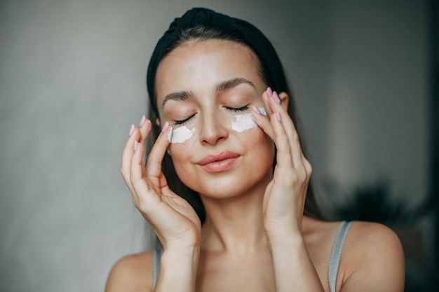 Brunette woman 30 years old with cream on her face