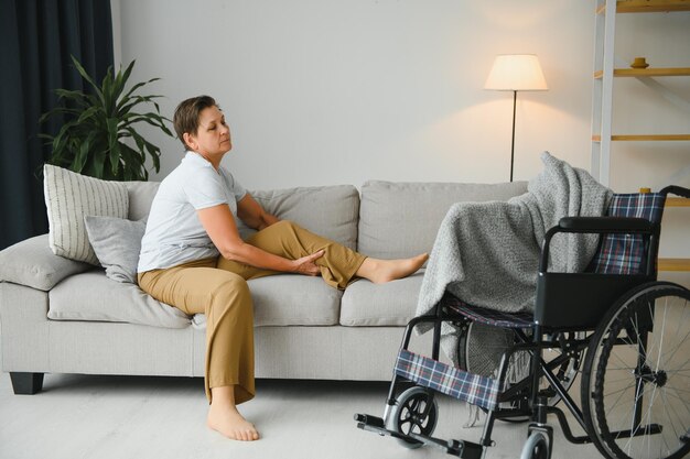 Brunette woman on couch near wheelchair