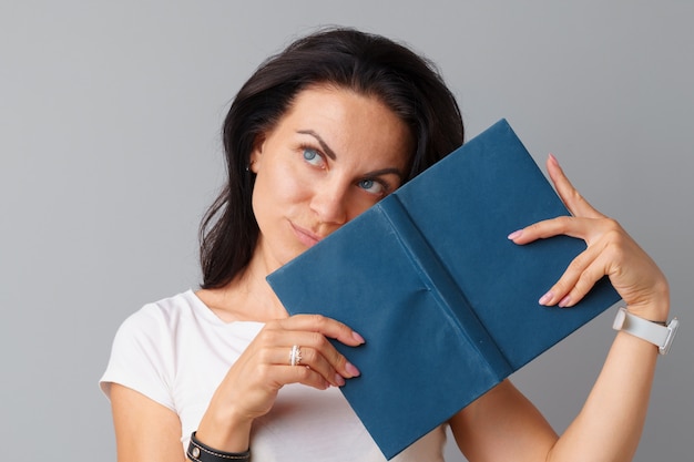 Brunette woman holding a book in her hands