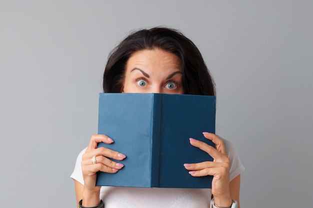 Brunette woman holding a book in her hands