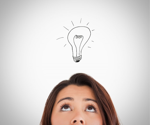 Brunette woman looking up on the bulb