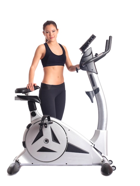 Photo brunette woman near bike exerciser