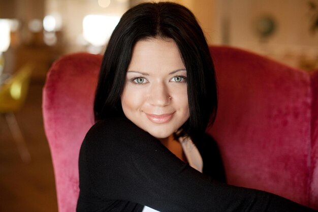 Brunette woman sit in chair