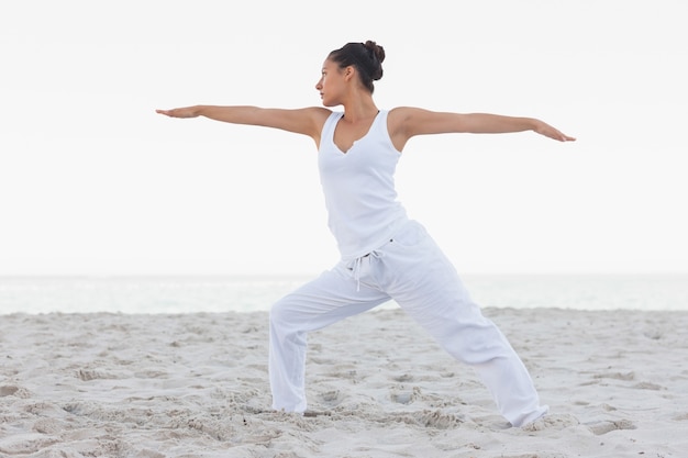 Brunette woman stretching in yoga pose