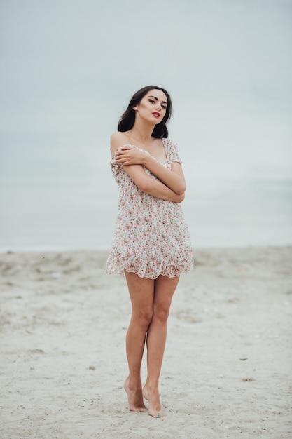 brunette woman wearing a floral dress