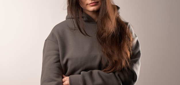 Brunette woman wearing a sweatshirt with a hood Beautiful girl blank one color jumper