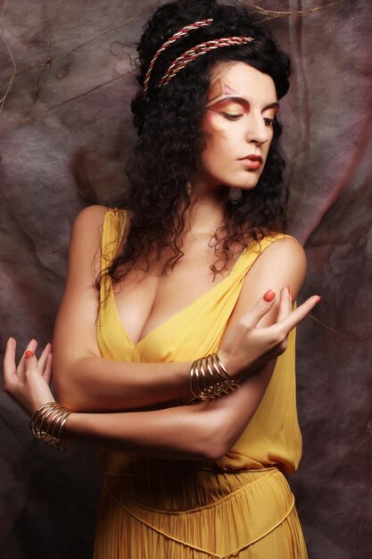 Brunette woman wearing yellow evening dress