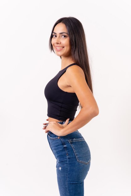 Brunette woman on a white background casting studio shots portrait in jeans smiling