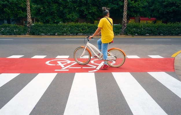 A Brunette woman with gray hair on a zebra crossing