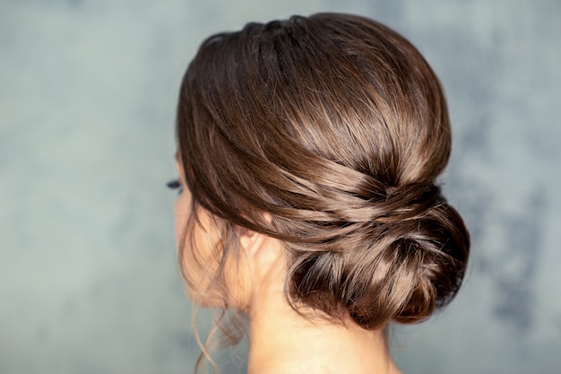 Brunette woman with middle bun hairstyle