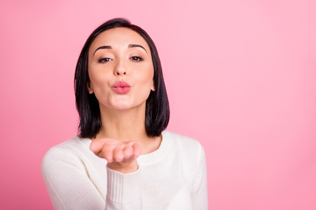 brunette woman with white pullover isolated on pink