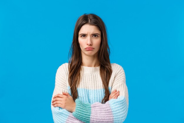 brunette woman with winter sweater angry