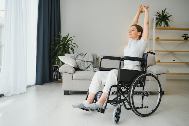 Brunette woman working out on wheelchair at home