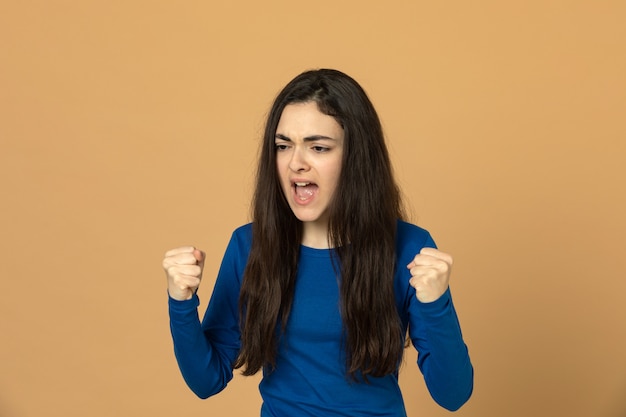 Brunette young girl wearing blue sweatshirt