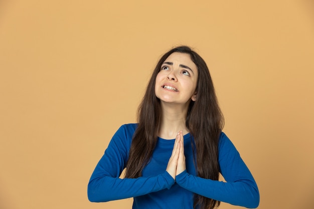 Brunette young girl wearing blue sweatshirt