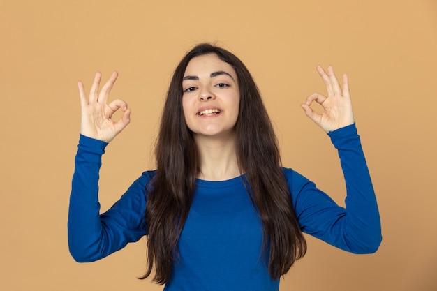 Brunette young girl wearing blue sweatshirt