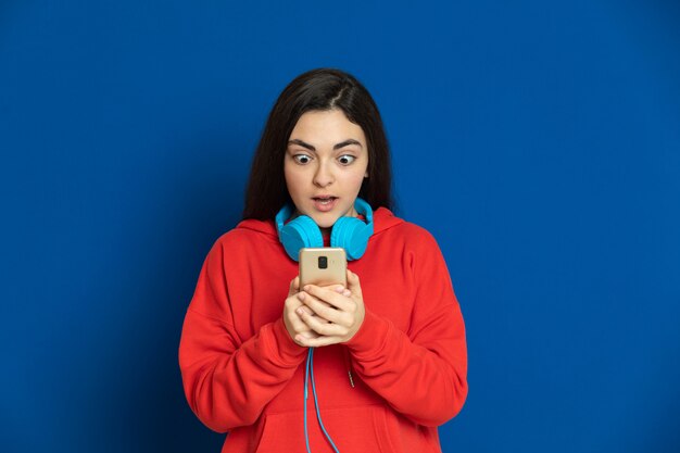 Brunette young girl wearing red sweatshirt