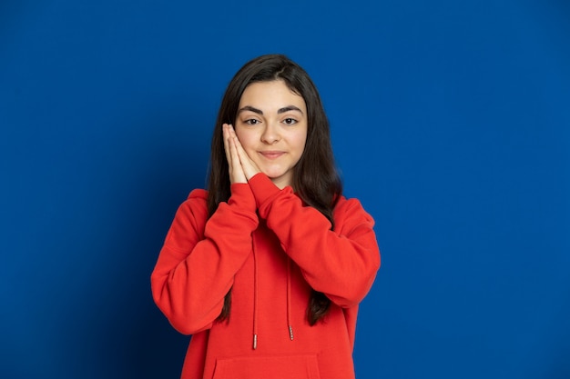 Brunette young girl wearing red sweatshirt