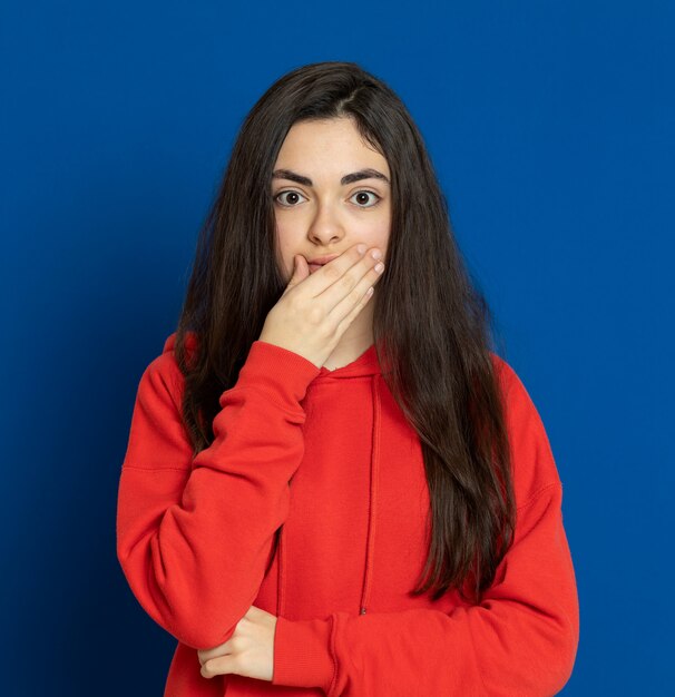 Brunette young girl wearing red sweatshirt