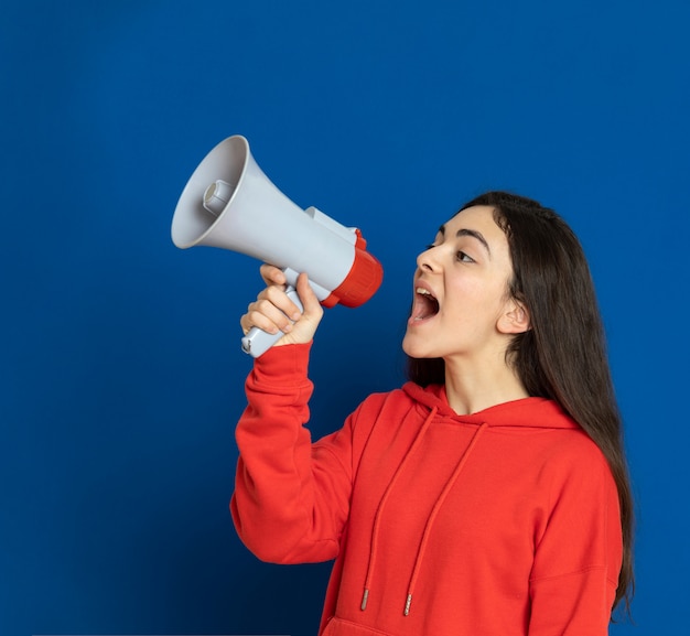 Brunette young girl wearing red sweatshirt