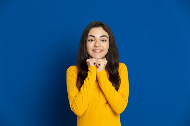 Brunette young girl wearing yellow jersey