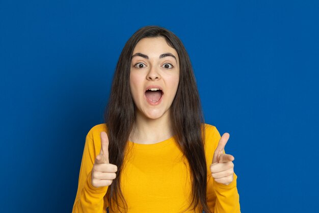 Brunette young girl wearing yellow jersey