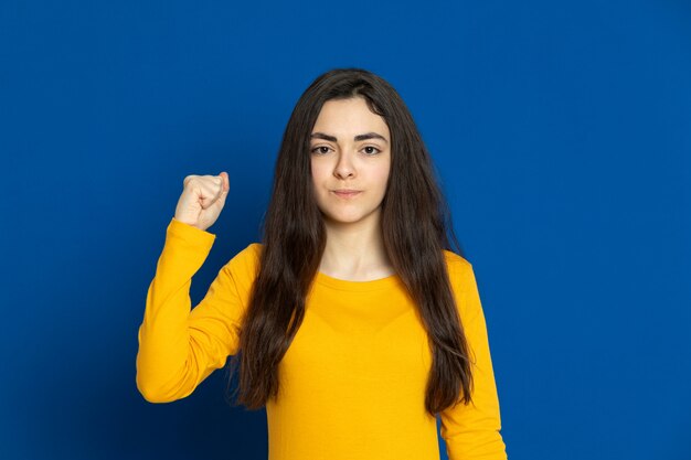 Brunette young girl wearing yellow jersey