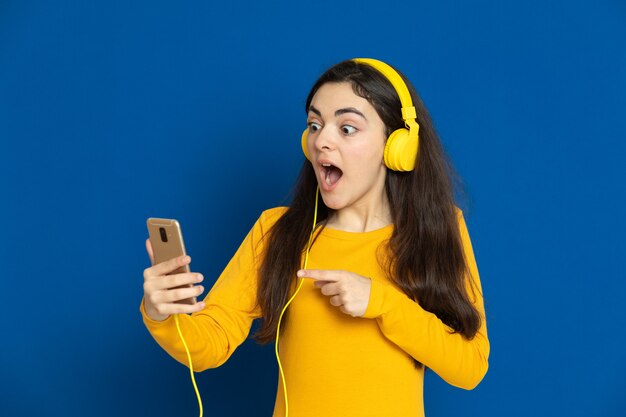 Brunette young girl wearing yellow sweatshirt