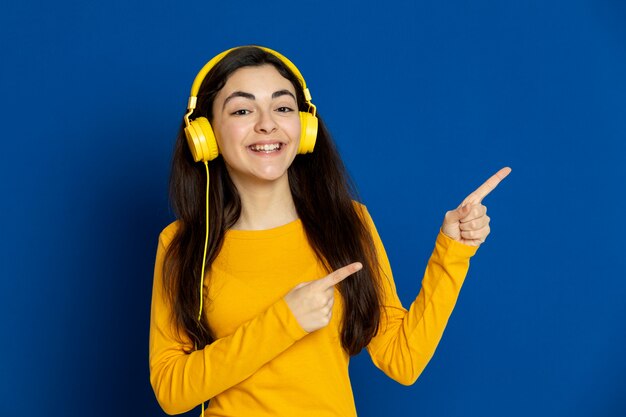 Brunette young girl wearing yellow sweatshirt