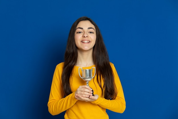 Brunette young girl wearing yellow sweatshirt