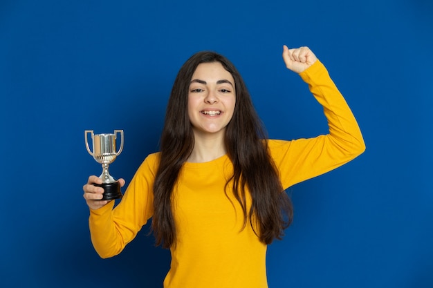 Brunette young girl wearing yellow sweatshirt