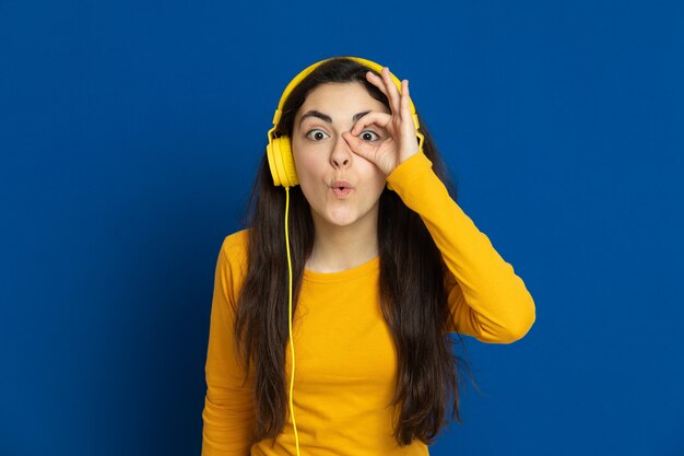 Brunette young girl wearing yellow sweatshirt