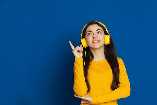 Brunette young girl wearing yellow sweatshirt