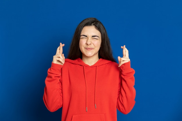 Brunette young girl with a red sweatshirt