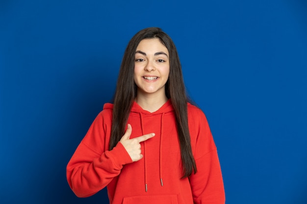 Brunette young girl with a red sweatshirt