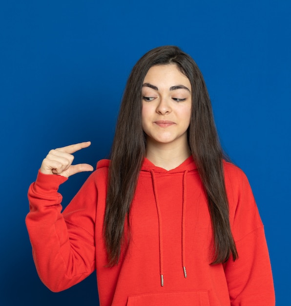 Brunette young girl with a red sweatshirt