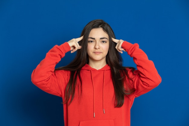 Brunette young girl with a red sweatshirt