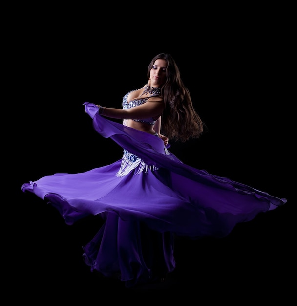 Brunette young woman dancing oriental dance