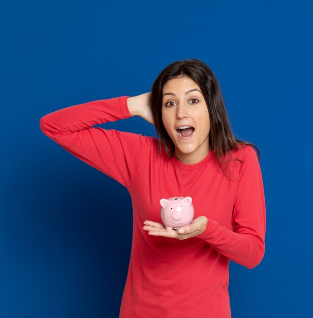 Brunette young woman gesturing over blue wall