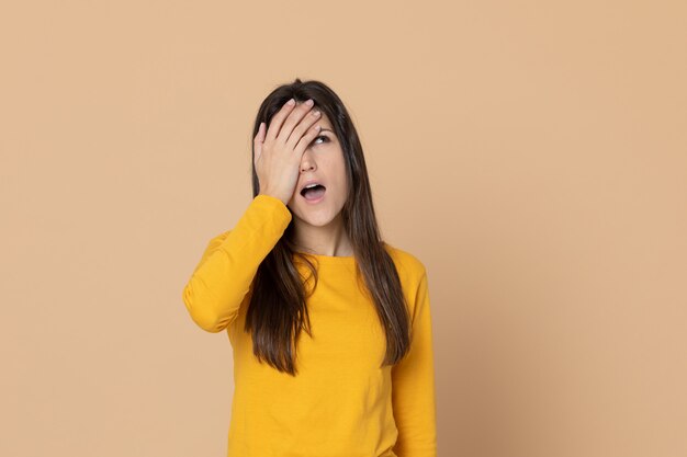 Brunette young woman wearing a yellow T-shirt