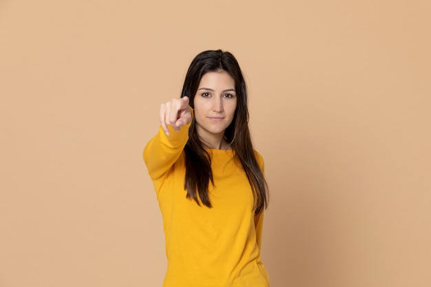 Brunette young woman wearing a yellow T-shirt