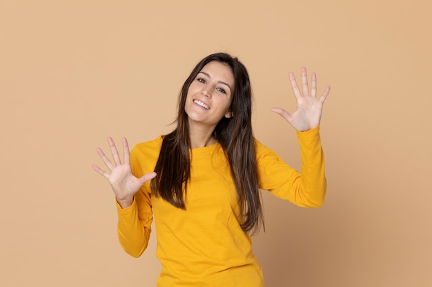 Brunette young woman wearing a yellow T-shirt