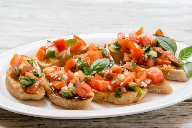 Bruscheta, antipasti Typical Italian with tomato, basil and toast