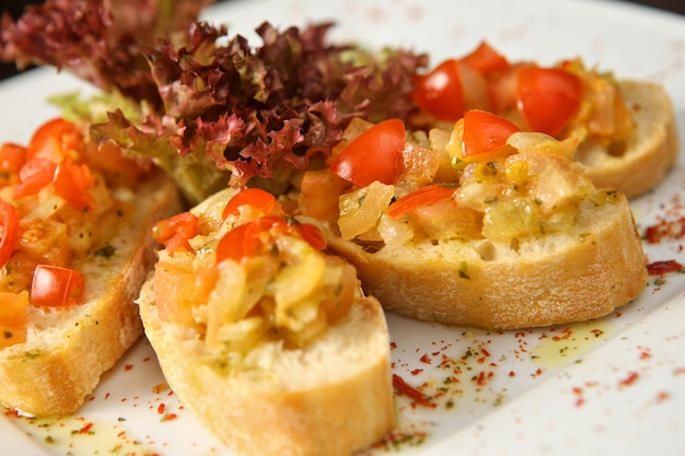 Bruschetta bread on plate with tomato and salad