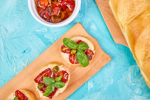 Bruschetta or crostini with sun dried tomatoes and capers