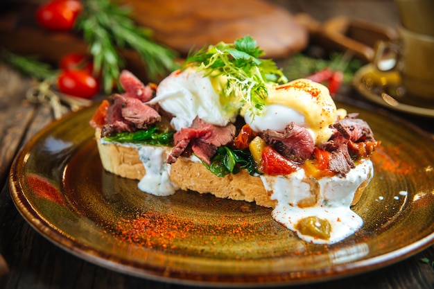 Bruschetta sandwich with eggs meat and vegetables