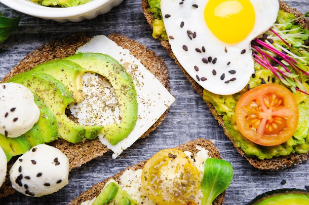 Bruschetta with avocado microgrin, quail eggs and adyghe cheese and mozzarella