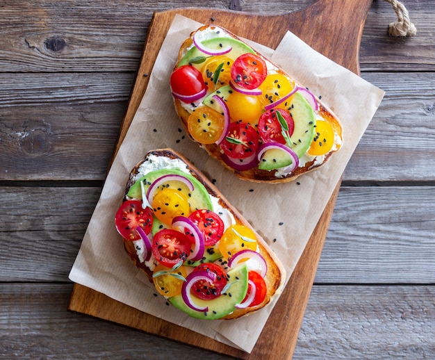 Bruschetta with avocado tomatoes onions and white cheese Vegetarian food Sandwich Italian food